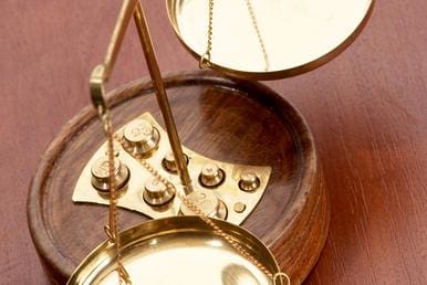 A close up of a scale on top of a wooden table