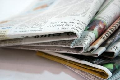 A close up of newspapers on top of each other