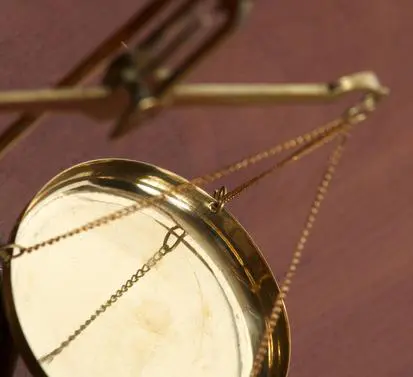 A close up of a mirror with chains hanging from it